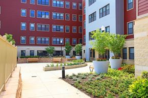 Washington apartment for rent - a courtyard with benches and plants in front of a building