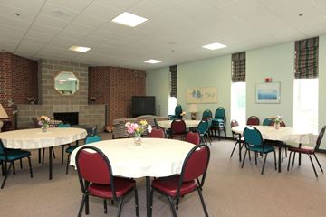 Holliston apartment for rent - a dining room with tables and chairs and a fireplace