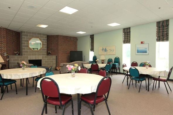Holliston apartment for rent - a dining room with tables and chairs and a fireplace