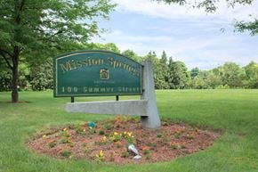 Holliston apartment for rent - a sign for themission springs park with flowers around it