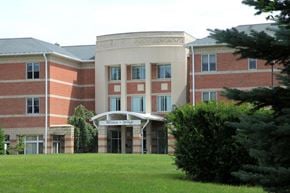 Holliston apartment for rent - a large brick building with a lawn in front of it