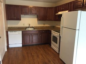 Providence apartment for rent - an empty kitchen with white appliances and brown cabinets
