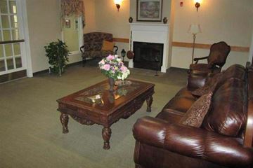 Harrisville apartment for rent - a living room with leather furniture and a fireplace