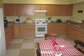 Harrisville apartment for rent - a kitchen with a table with a checkered table cloth