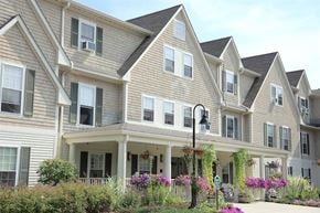 Harrisville apartment for rent - a row of houses with flowers in front of them