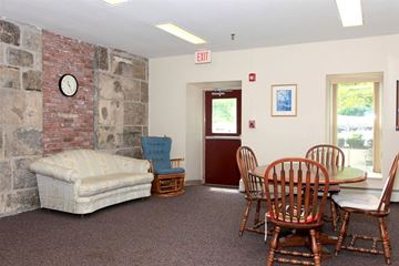 Uxbridge apartment for rent - a living room with a couch and a table with chairs