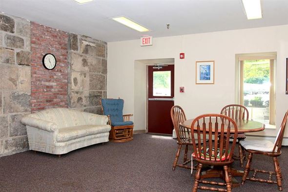 Uxbridge apartment for rent - a living room with a couch and a table with chairs