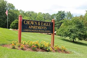 Uxbridge apartment for rent - a sign for crown  eagle apartments in a field