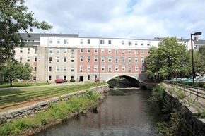 Uxbridge apartment for rent - a river running under a bridge in front of a building
