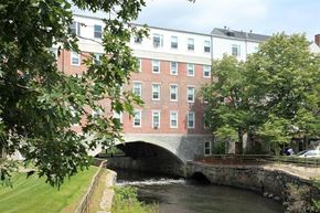 Uxbridge apartment for rent - a bridge over a river in front of a building