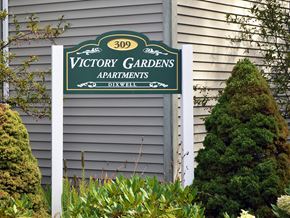 New Haven apartment for rent - a sign for victory gardens apartments on the side of a house