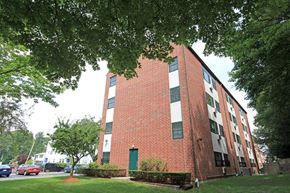 Jamaica Plain apartment for rent - a brick building with a green lawn and trees