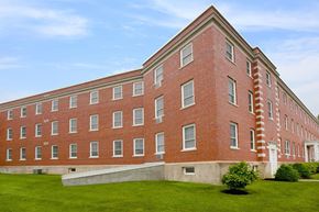 Westfield apartment for rent - a large brick building with a green lawn