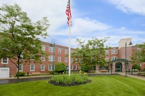 Westfield apartment for rent - a flagpole with an flag in front of a building