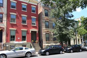 Albany apartment for rent - a red brick building with cars parked in front of it