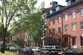 Boston apartment for rent - a row of houses on a street with cars parked