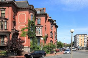 Boston apartment for rent - a row of brick buildings on a city street with cars