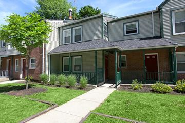 New Haven apartment for rent - a green and brick house with a sidewalk in front of it