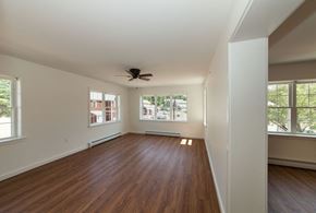 Greenfield apartment for rent - a living room with wood floors and a ceiling fan