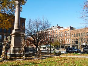 Greenfield apartment for rent - a monument in the middle of a park in front of a building