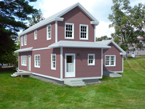 Greenfield apartment for rent - a red house with a gray roof on a lawn