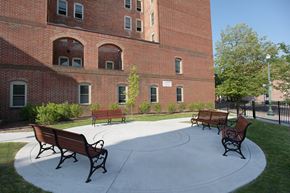 Troy apartment for rent - a group of benches in front of a brick building