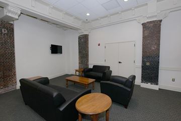 Troy apartment for rent - a living room with couches and a table