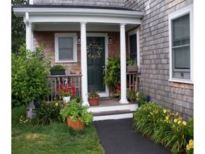 Edgartown apartment for rent - the front porch of a house with columns and potted plants