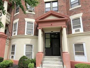 Dorchester apartment for rent - the front of a brick apartment building with a black door