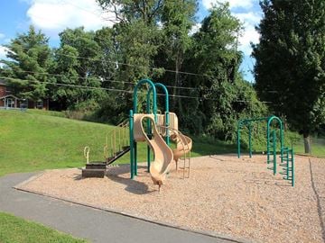 Vernon apartment for rent - a playground with a slide in a park