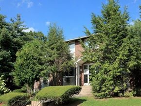 Vernon apartment for rent - a brick house with trees in front of it