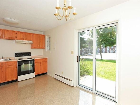 Torrington apartment for rent - a kitchen with a sliding glass door and a stove