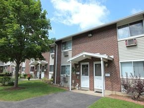 Torrington apartment for rent - the front of a brick apartment building with a white door