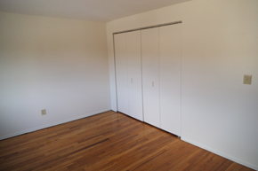 Torrington apartment for rent - a bedroom with white closets and wood floors