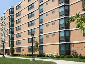 Chicago townhouse for rent - a large brick building with a sidewalk in front of it