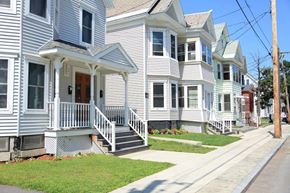 Schenectady apartment for rent - a row of white houses on a sidewalk