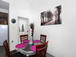 Philadelphia apartment for rent - a dining room with a table and chairs and a painting on the wall