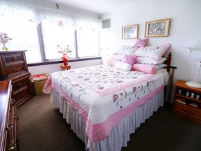 University Park apartment for rent - a pink and white bedroom with a bed and a dresser