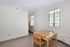 New Haven apartment for rent - a dining room with a wooden table and two windows