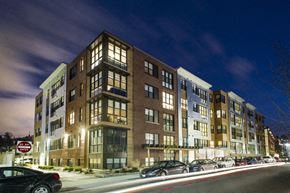 Allston apartment for rent - a rendering of a building on a city street at night