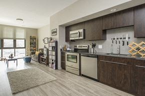 Allston apartment for rent - a kitchen with stainless steel appliances and wooden cabinets