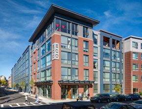 Allston apartment for rent - a rendering of a new apartment building on a city street