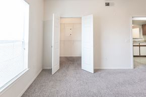 Converse apartment for rent - an empty bedroom with a closet and a window