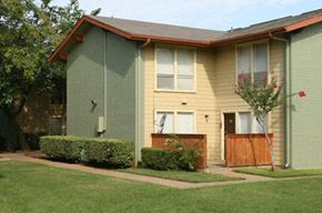 Euless apartment for rent - A house with a green siding and a brown fence.