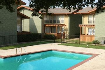 Euless apartment for rent - A swimming pool in front of a building.