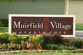 Euless apartment for rent - A brown sign that says Muirfield Village Apartments.