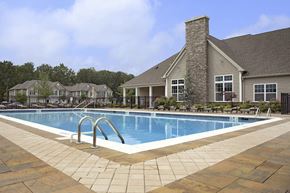 Howell apartment for rent - a swimming pool in front of a house