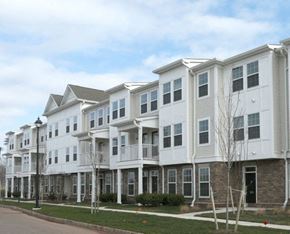 Skillman townhouse for rent - a row of white apartment buildings on the side of a street