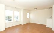 Skillman townhouse for rent - an empty living room with a hard wood floor and three windows
