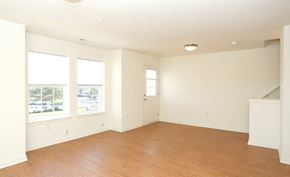 Skillman townhouse for rent - an empty living room with a hard wood floor and three windows